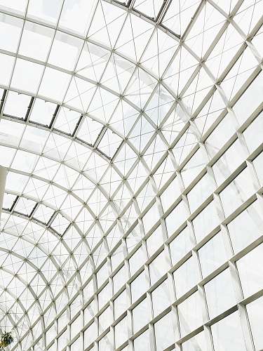 building low angle photography of clear glass ceiling window