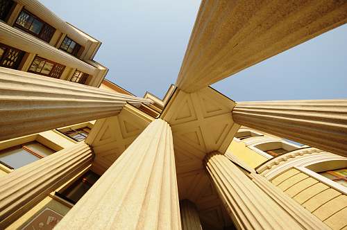 building low-angle photography of concrete pillars of a building wood