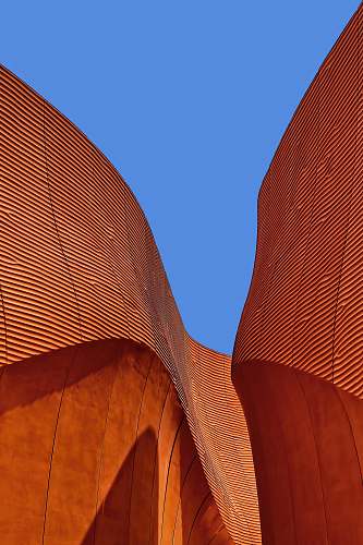 building minimalist photography of brown wavy structure roof