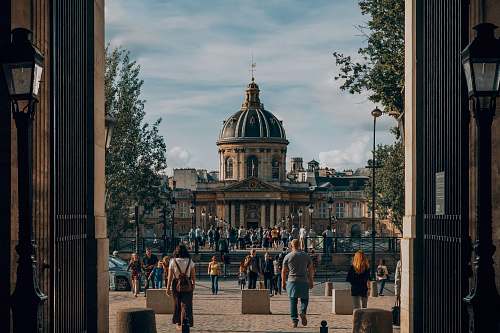 building people on park in front of domed building human