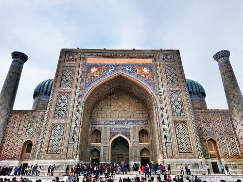 building people standing outside mosque during daytime dome