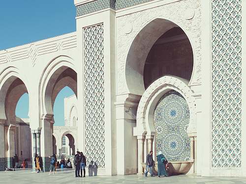 building people walking beside triumphal arch dome
