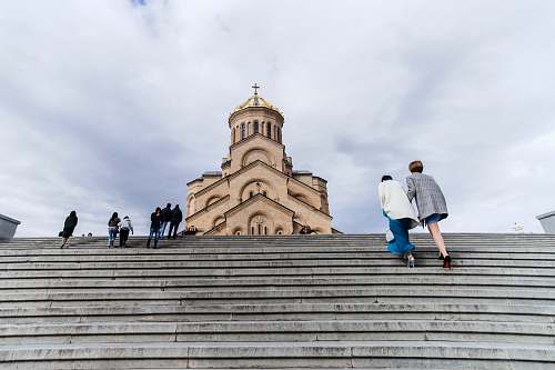 banister people walking near church handrail