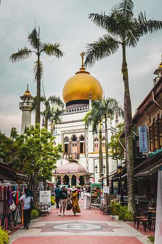 building people walking near mosque dome