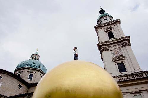 building person standing on gold dome dome
