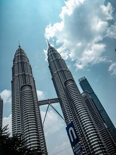 building Petronas Tower under blue and white skies spire