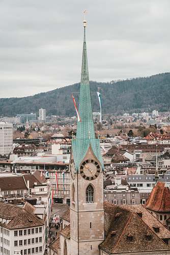 building photography of brown and blue concrete buildings during daytime spire