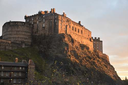 building photography of brown castle on top of mountain during daytime castle