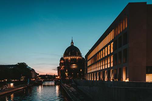 building photography of river beside building during sunset dome