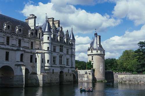 building sailing boat near white castle castle