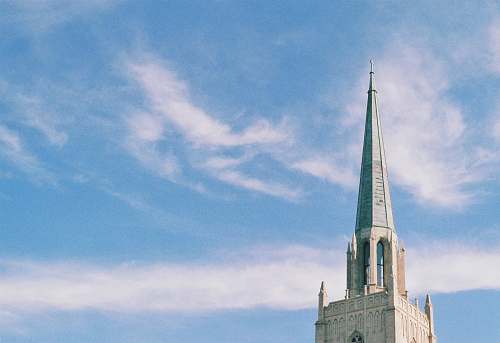 building selective photography of brown building at daytime steeple