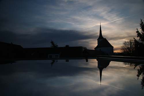 building silhouette church near body of water spire