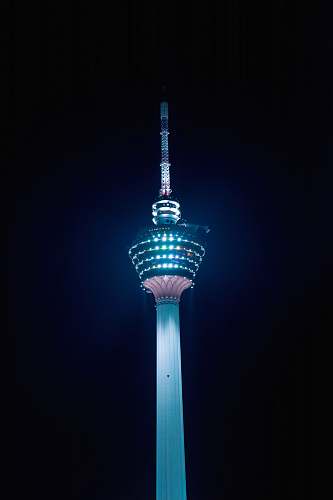 building teal and red tower during night time tower