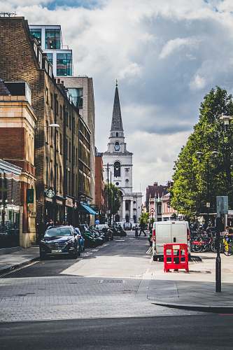 building vehicle sparked beside building during daytime spire