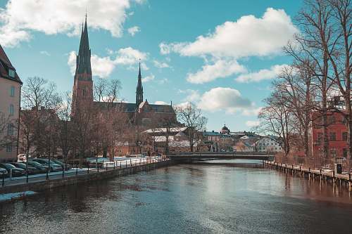 building view of body of water between buildings steeple