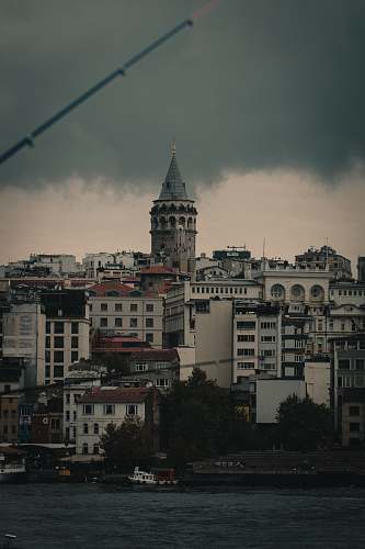 building white and black concrete building under gray sky tower