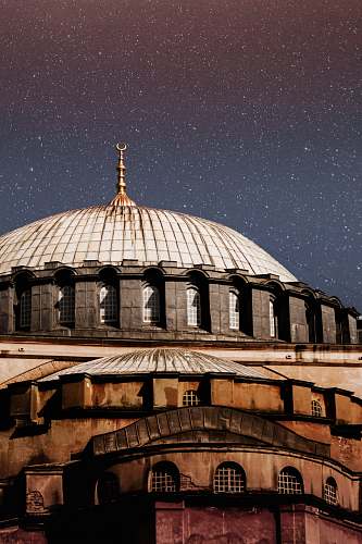 building white and brown domed building under starry sky dome