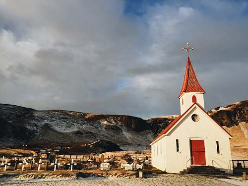 building white and red cathedral near mountain spire