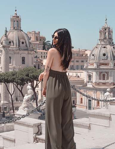 building woman in gray dress standing outdoor during daytime dome