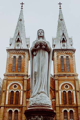 building woman religious statue tower