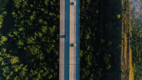 architecture aerial photography of vehicle traveling on bridge during daytime tower