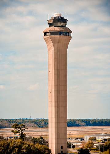architecture brown control tower under grey sky at daytime tower