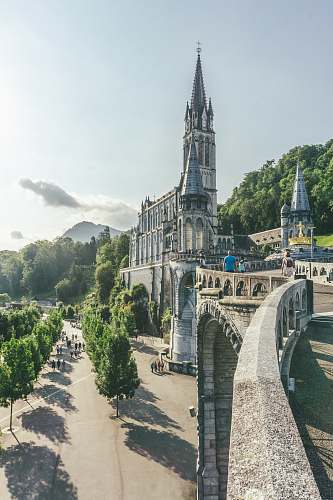 architecture gray concrete building under clear blue sky spire