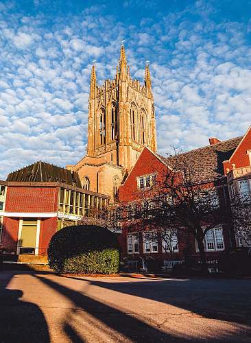architecture low-angle photography of a cathedral under cloudy sky spire
