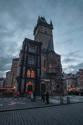 architecture people standing near building gray sky city