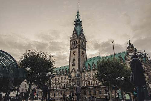 architecture people walking near Hamburg City Hall in Germany under gray skies during daytime tower