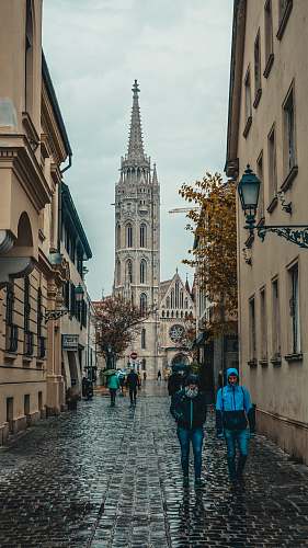spire people walking on road tower