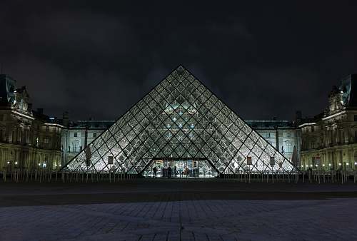 architecture pyramid-shaped clear glass building during night pyramid