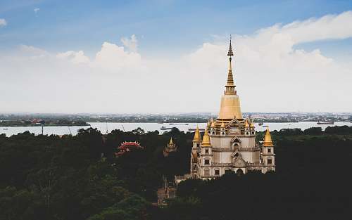 architecture white and yellow mosque across body of water spire