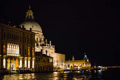 architecture white historic building near body of water during night time dome