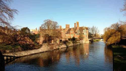 architecture brown brick building along the river building