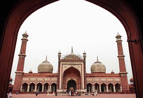 architecture low-angle photography of maroon and gray mosque during daytime building