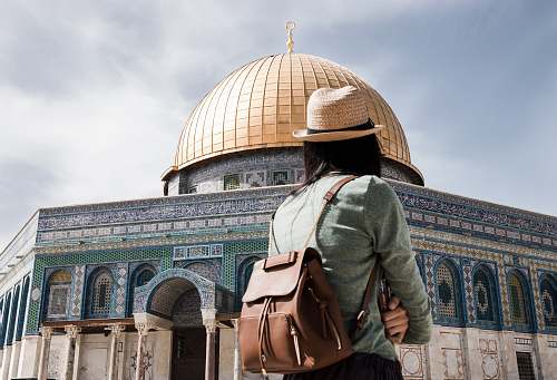 building person wearing brown leather backpack architecture