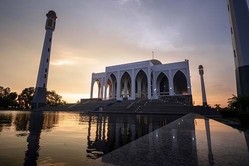 building white mosque with pond in front architecture