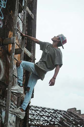  man climbing on ladder 