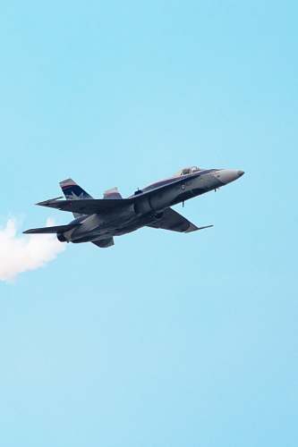 airplane selective focus photography of gray fighter plane on air during daytime bomber