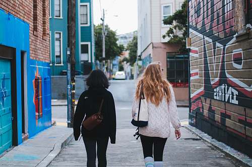 clothing two women in sweaters walking on street human