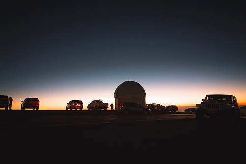 vehicle assorted vehicles parked under gray sky during sunset observatory
