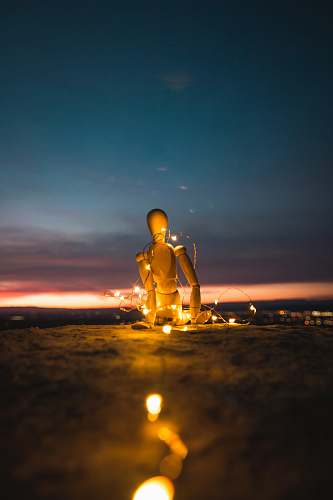 buddha marionette doll on stand with LED string lights worship