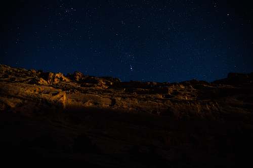 night landscape photography of hill during nighttime outdoors
