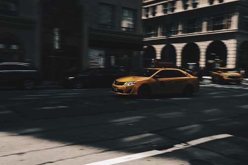 cab selective focus photo of beige metallic sedan car