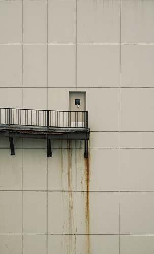 handrail white concrete wall during daytime wall
