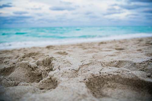 ocean close up photography of footprints on shore sea