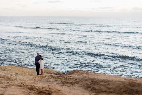 ocean man and woman facing body of water couple