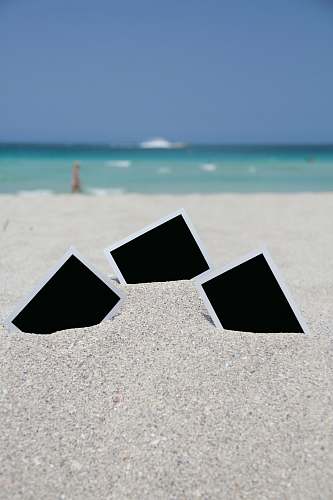water three photo frames on seashore near sea ocean