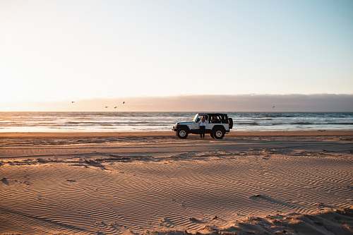 coast white wrangler beside the beach ocean